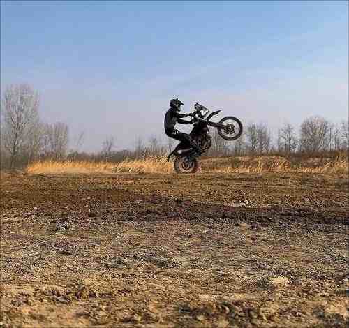 Riding an electric off-road motorcycle in open fields